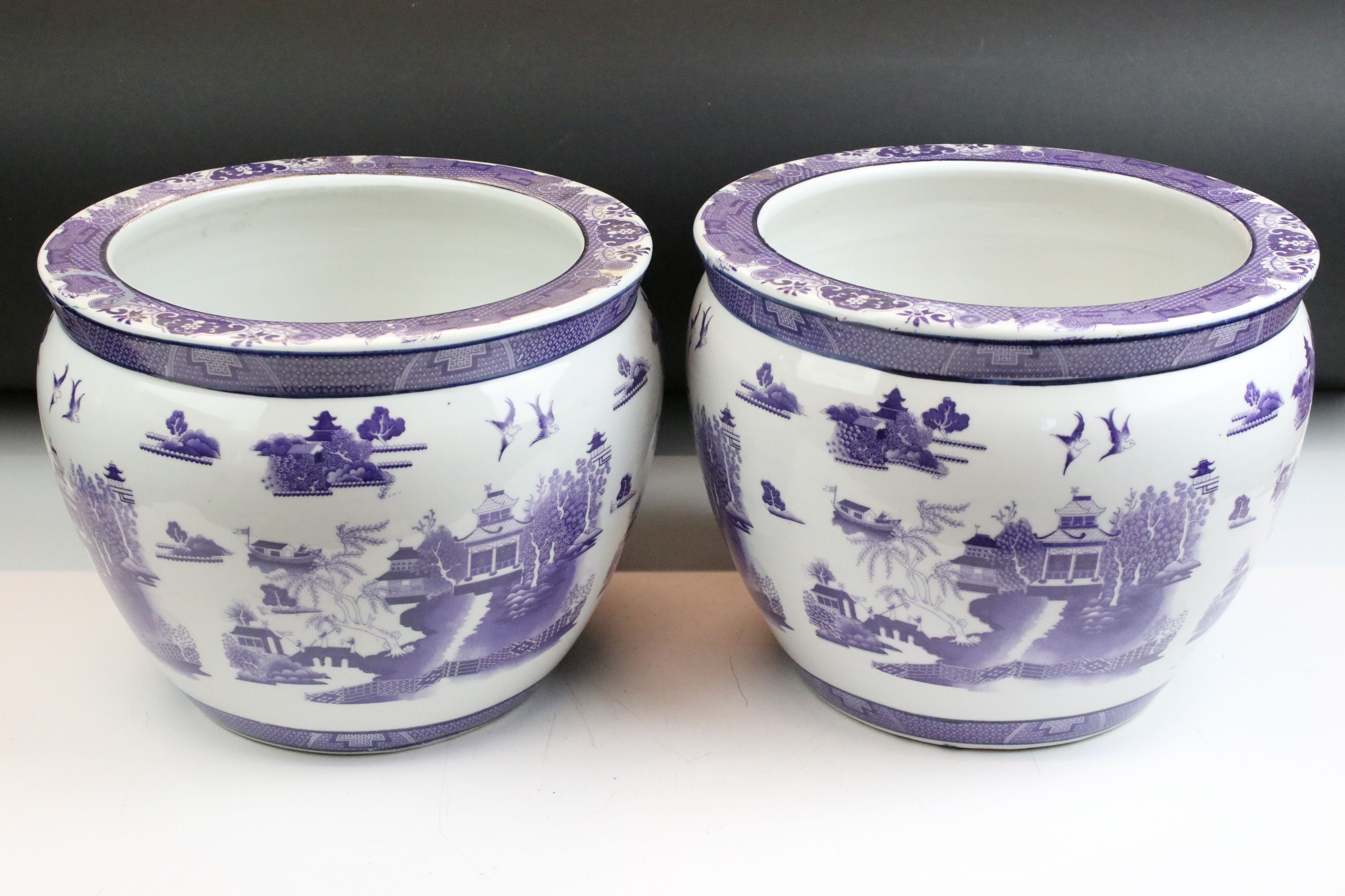Pair of 20th Century Chinese planter pots. Each having purple printed landscape scenes to the