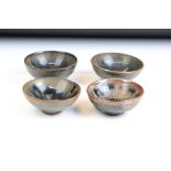 Set of four Chinese blue and brown drip glaze bowls. Measures 9cm diameter.