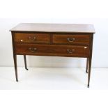 Edwardian Mahogany Inlaid Three Drawer Chest raised on square tapering legs with castors, 104cm long