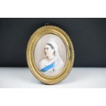 An antique oval ceramic portrait of Queen Victoria.