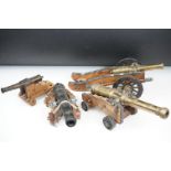 A collection of four miniature decorative Canon's, all with cast metal barrels and wooden carriages.