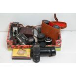 A collection of mid 20th century cameras and binoculars to include Zenith and Kodak examples.