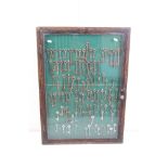 Large collection of old keys contained within a glazed key cabinet.