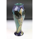 20th Century Moorcroft baluster vase in the black tulip pattern having tube lined floral decoration.
