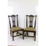 A pair of mahogany Georgian side chair of Irish design and needlework seats.