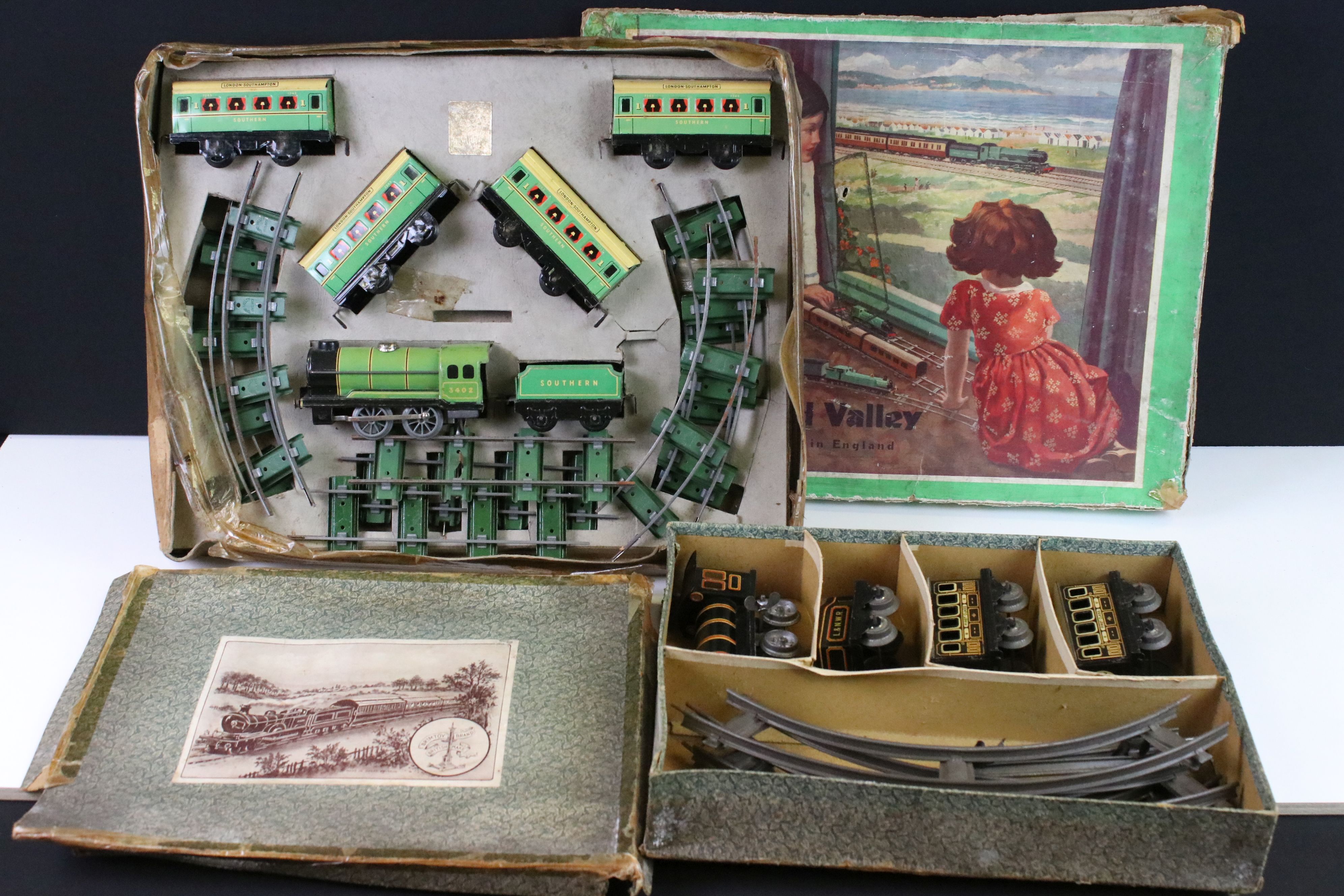 Two early-mid 20th C boxed tin plate train sets to include Brimtoy Clockwork Train No 37/0 Colour