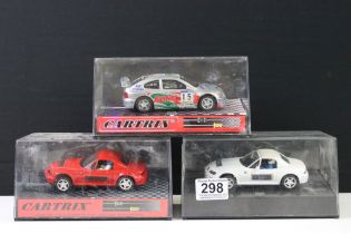 Three cased Cartrix slot cars to include a BMW Z3, 0302-E Hyundai Accent WRC Catalunya 2000 and a