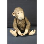 Mid 20th C straw-filled mechanical monkey, jointed, approx 34cm high