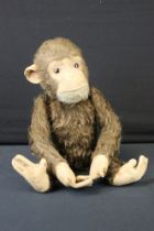 Mid 20th C straw-filled mechanical monkey, jointed, approx 34cm high