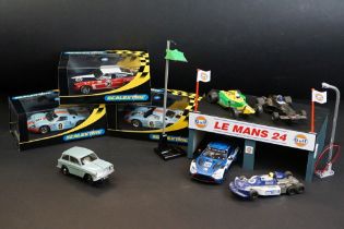 Three cased Scalextric slot cars to include C2403 Ford GT 40 1968 No 9, C2404 Ford GT40 1969 No 6,