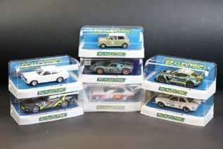 Seven cased Scalextric slot cars to include C4182 Ford Mustang GT4, C4036 Aston Martin Vantage