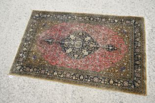 Iranian Tabriz Silk Rug, the red and green ground decorated with a central medallion surrounded by