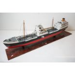 Scratch built painted wooden model of an oil tanker, raised on a wooden stand (stand measures