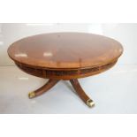 Yew wood Circular Coffee Table raised on a pedestal support with four splay legs terminating with