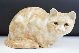 Winstanley ceramic ginger cat having yellow glass eyes. Measures 28cm wide. Signed to the base.
