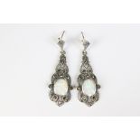 A pair of silver marcasite and art deco style opal paneled drop earrings
