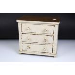 A vintage painted 3 drawer table top chest. Measures approx 29cm W x 26.5cm H