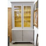 19th century Bookcase on Cupboard, later painted grey with a yellow interior, the upper section with