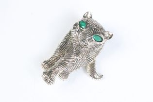 A silver art deco style cat brooch set with emerald eyes
