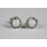 A pair of silver and opal and CZ stud earrings