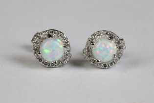 A pair of silver and opal and CZ stud earrings