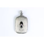 A vintage sterling silver scent bottle with floral decoration and central floral ceramic cabochon.