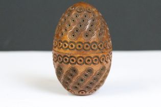 A hand carved Coquilla nut string dispenser.