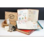 A small collection of British and world stamps contained within three albums together with a small