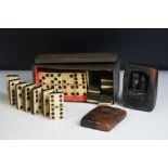 A set of early 20th century bone dominoes within a tin box together with an unusual handmade clay