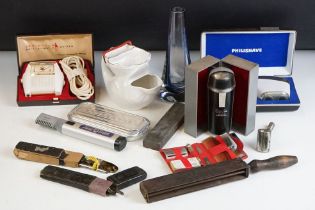 A collection of shaving related collectables to include cut throat and electric examples together