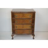 Early 20th century walnut bow front chest of four long drawers, raised on small cabriole legs