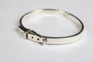 A silver belt shaped bangle