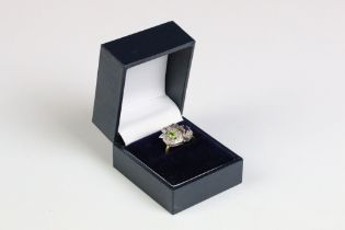 A gold plated on silver ring in the form of two hearts set with amethyst and peridot