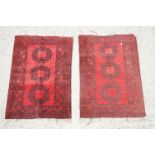 Pair of Eastern Red Ground Prayer Mats or Small Rugs, each decorated with three guls within a