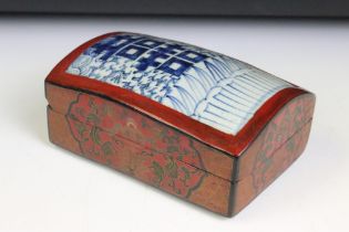 Chinese red lacquered box with gilt details and blue & white ceramic panel to lid, approx 17.5cm