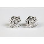 A pair of silver CZ designer style stud earrings