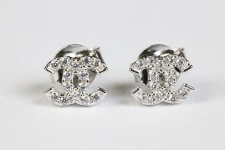 A pair of silver CZ designer style stud earrings