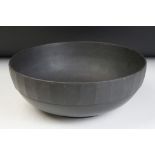 Keith Murray for Wedgwood basalt centre piece bowl of footed form having a faceted rim. Measures