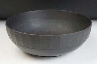 Keith Murray for Wedgwood basalt centre piece bowl of footed form having a faceted rim. Measures