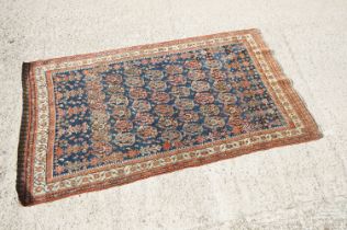 Eastern Kashqai Blue and Red Ground Rug with stylised floral pattern within a border, approx.