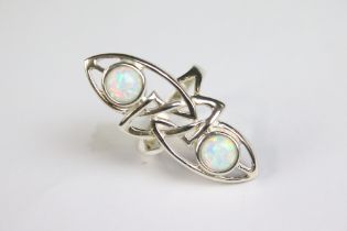 A silver art nouveau style dress ring with two opal panels