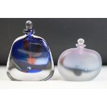 Two studio art glass bottles by Chris Comins to include a blue interior bottle with elongated stoppe