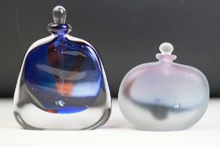 Two studio art glass bottles by Chris Comins to include a blue interior bottle with elongated stoppe