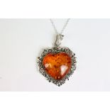 A substantial silver and amber heart shaped pendant necklace