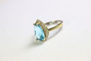 A silver ring set with CZ and faux blue topaz ring