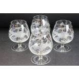 Set of four brandy glasses each having etched hunting scenes to the sides. Measures 11cm tall.