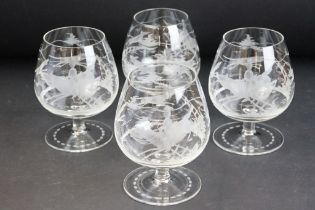 Set of four brandy glasses each having etched hunting scenes to the sides. Measures 11cm tall.