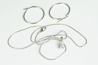 A pair of silver hoop earrings and CZ pendant necklace