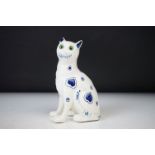 In the manner of Emile Galle, French Pottery Seated Cat decorated with a blue pattern on a white