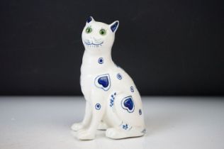 In the manner of Emile Galle, French Pottery Seated Cat decorated with a blue pattern on a white